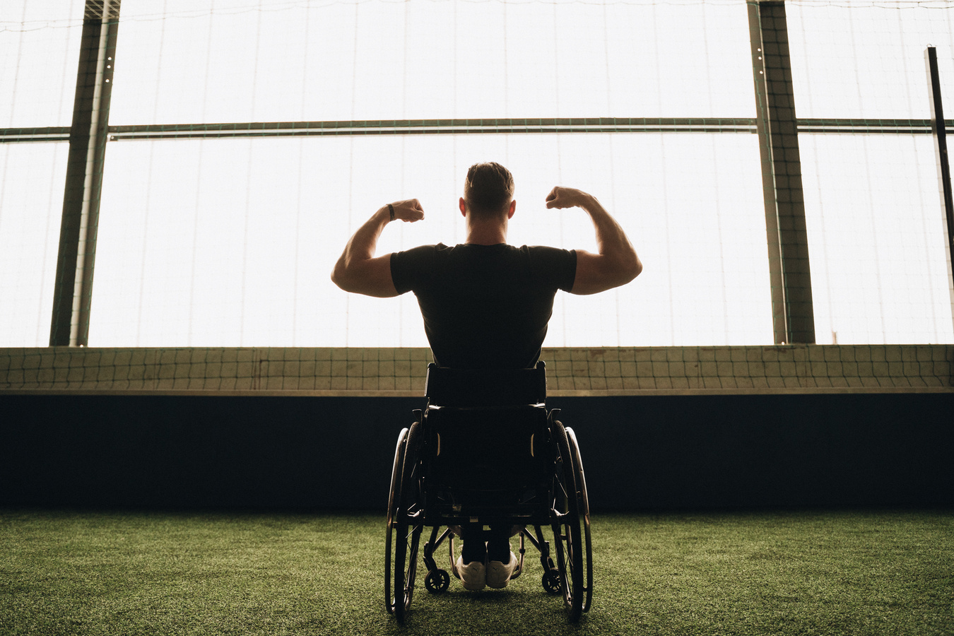 Man in a Wheelchair Flexing His Muscles